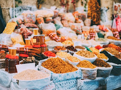 local food 2 About Homey Tbilisi, Georgia. Market Bazar Abundant Counter Of Dried Fruit And Jars Of Honey On Sale.